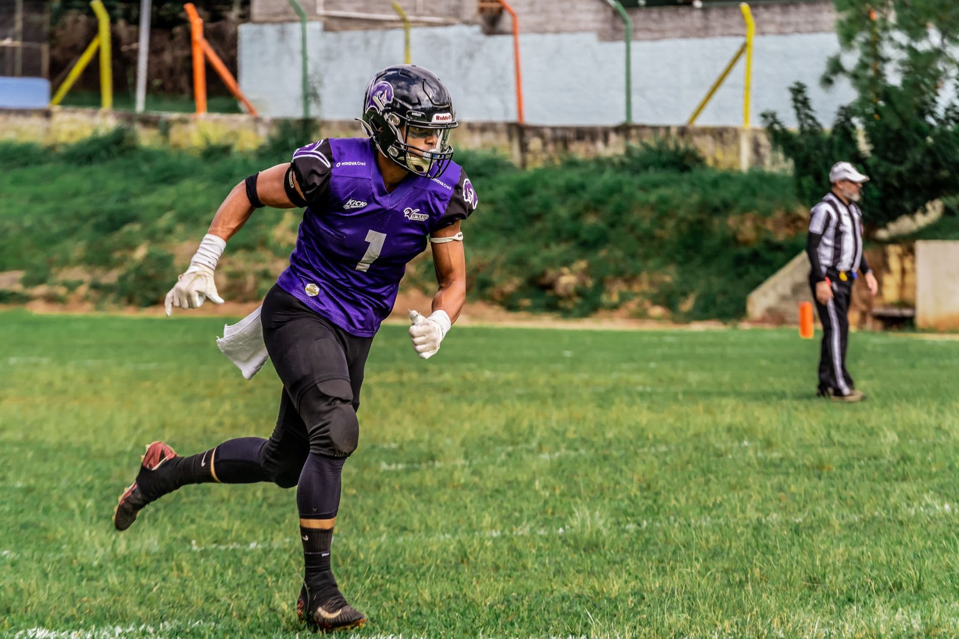An American football player running with the ball