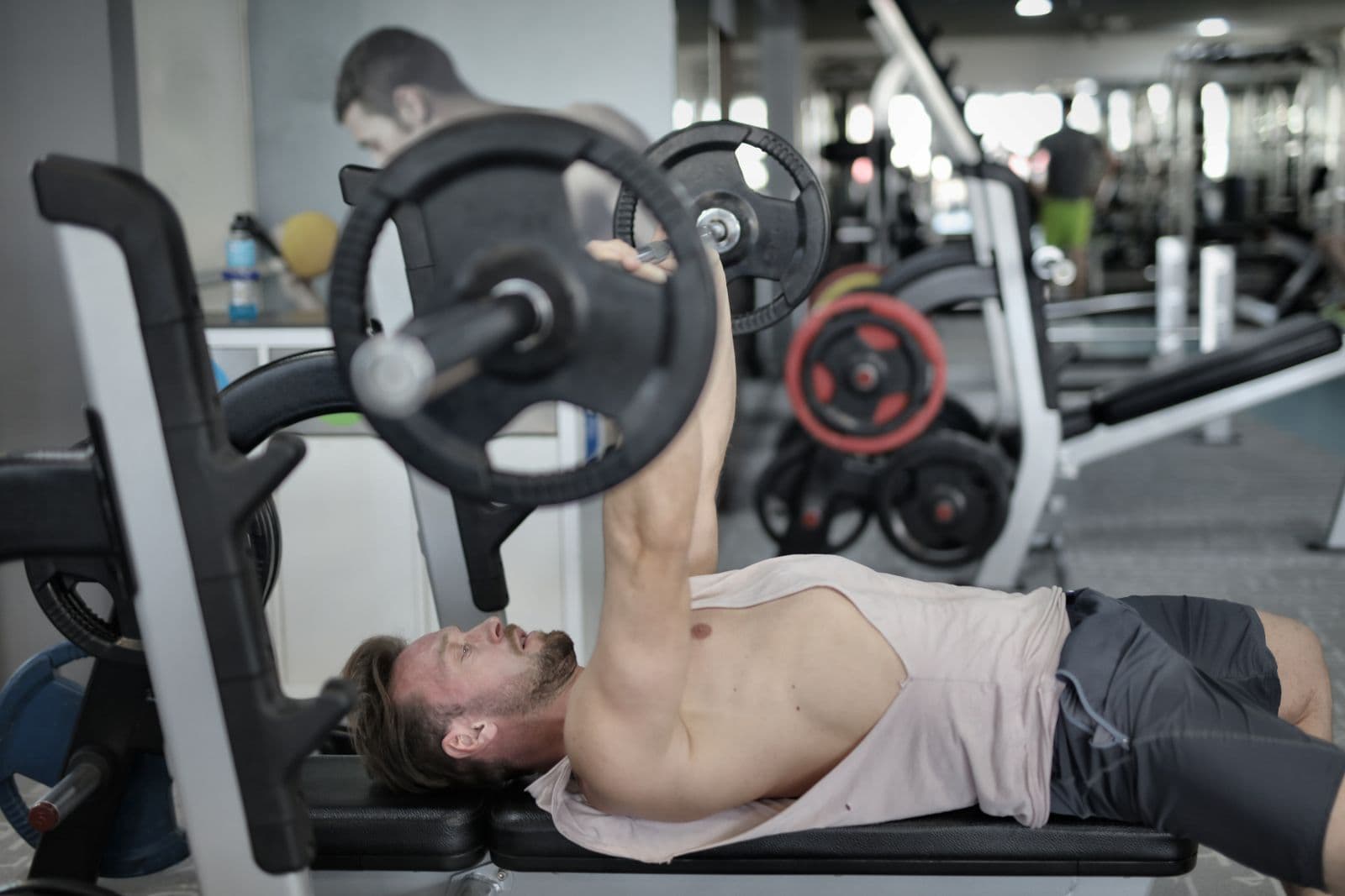 A bench press from the side, the bar held over the chest