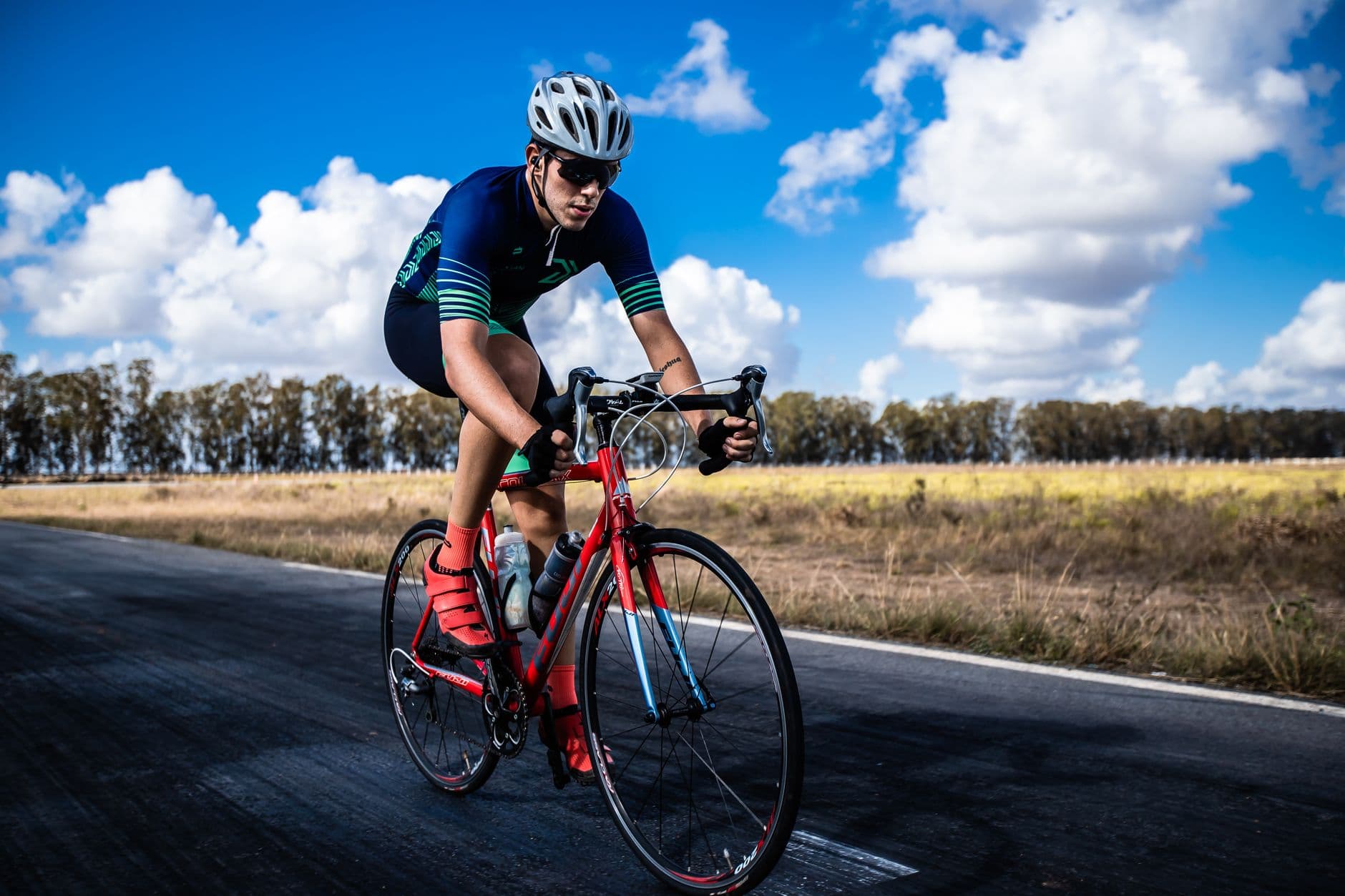 A cyclist on a road bike riding an open road