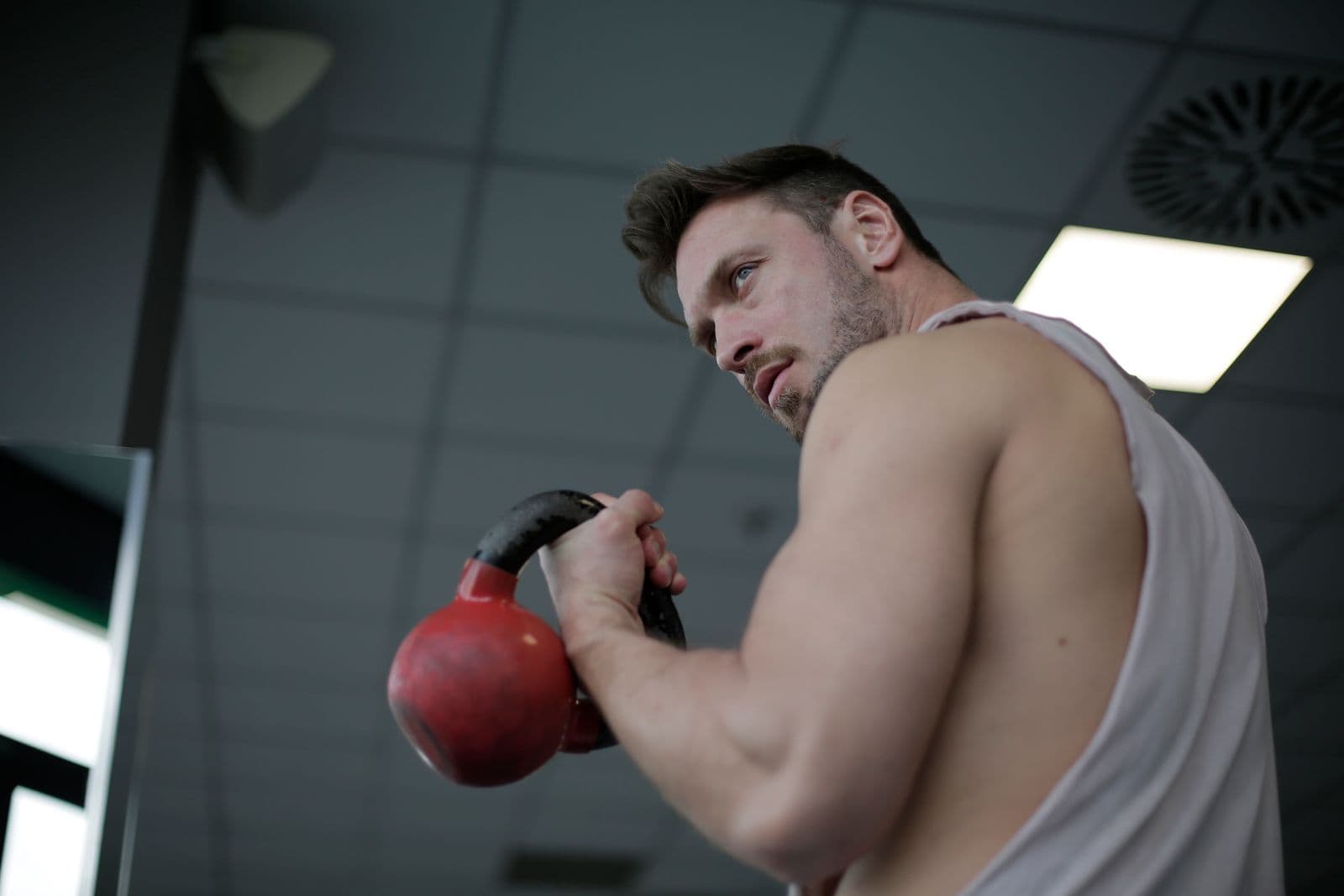 A kettlebell swing seen from low down, the bell still in the hand