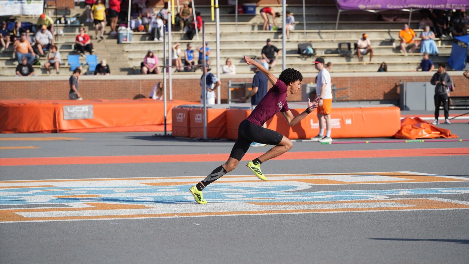 A sprinter at full speed on an outdoor track