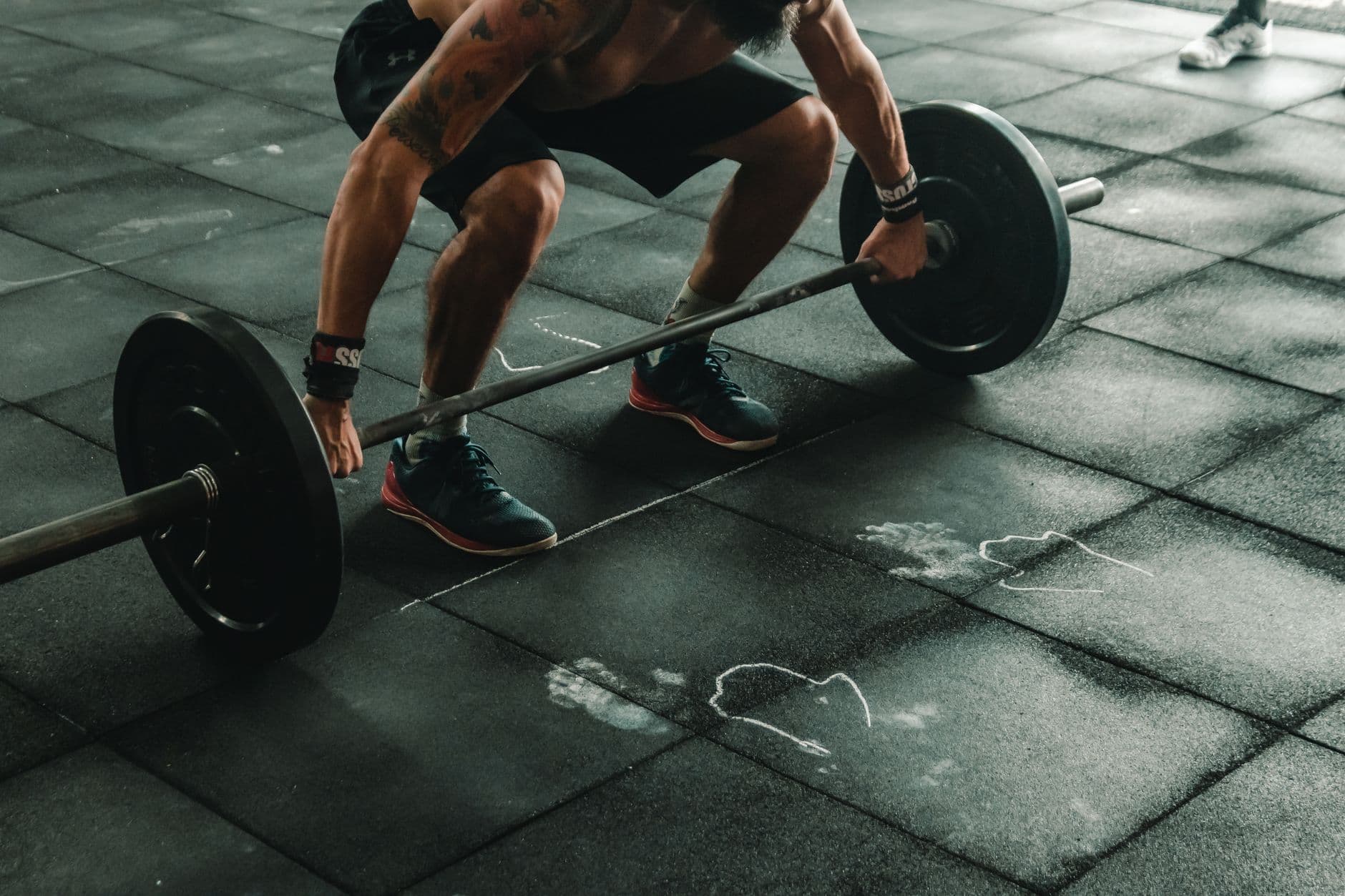 A lifter setting up over a loaded barbell