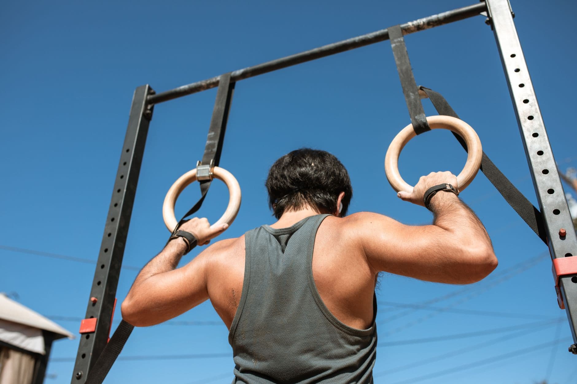 An athlete holding a support position on gymnastic rings